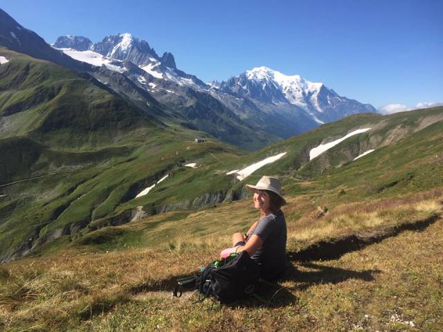 Sylvia sitting on a mountainside