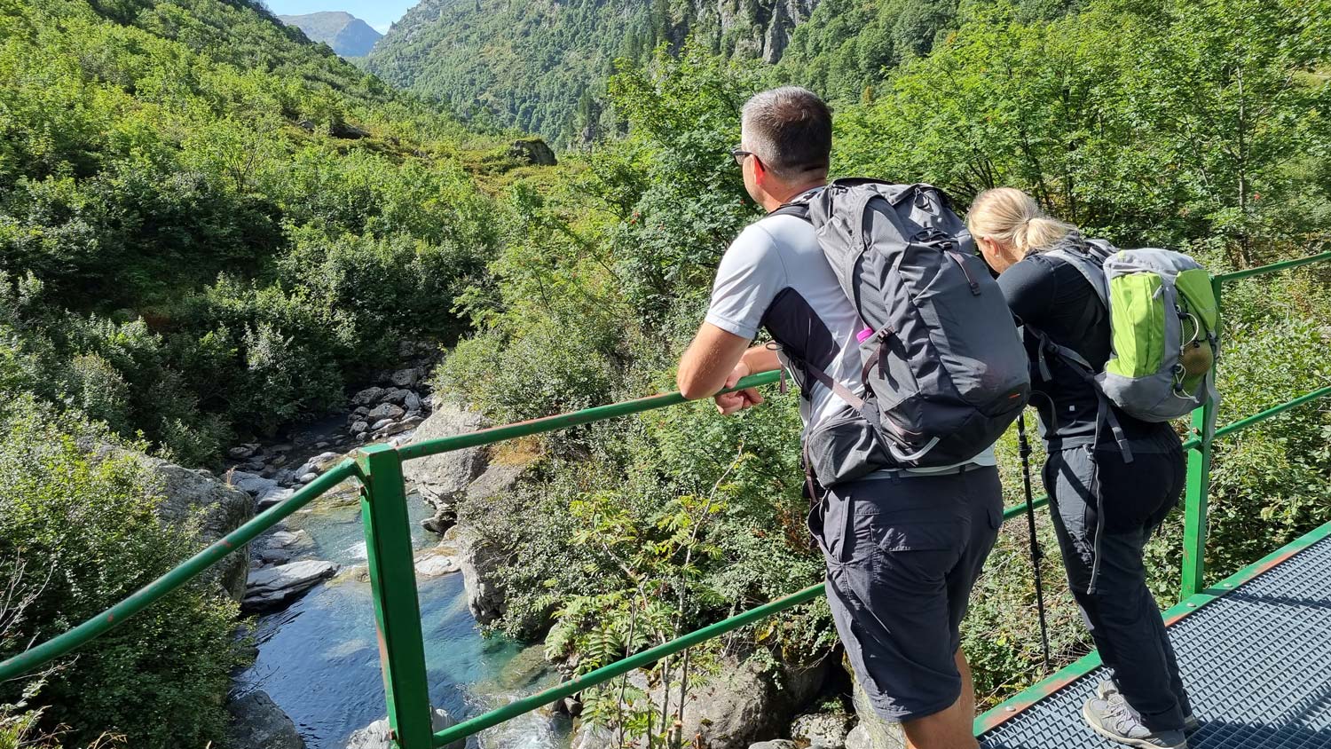 View of two people watching a river on the way to the Moëde mountain hut