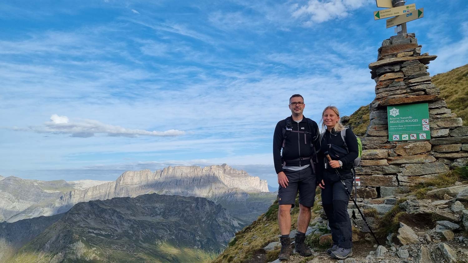Two people standing in front of the view of the Anterne Mountain